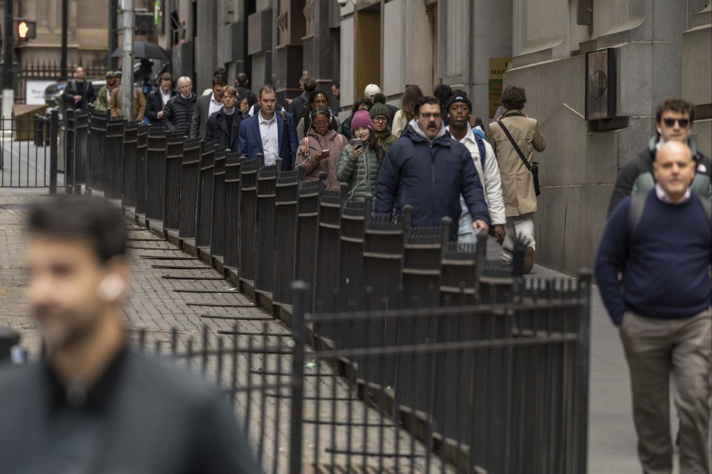 Commuters pass the New York Stock Exchange. The unemployment rate ticked up to 4.3 per cent, also worse than expected and the highest level since 2021. Photo: AP