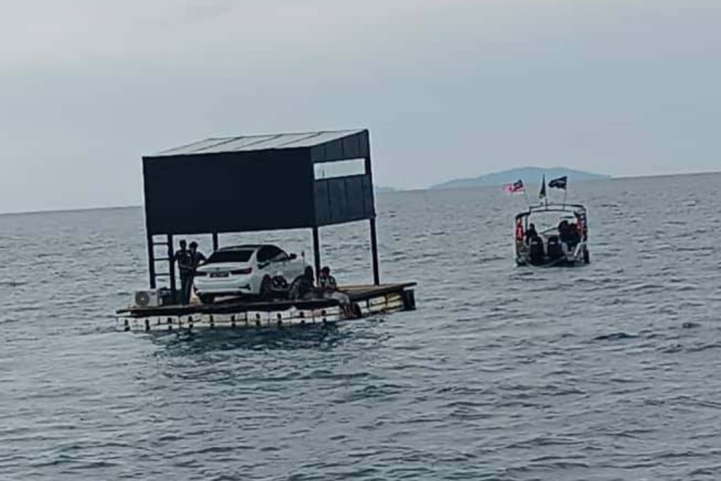 A floating platform with a luxury car on it is seen being towed at sea on Wednesday. Photo: Facebook/MMEA
