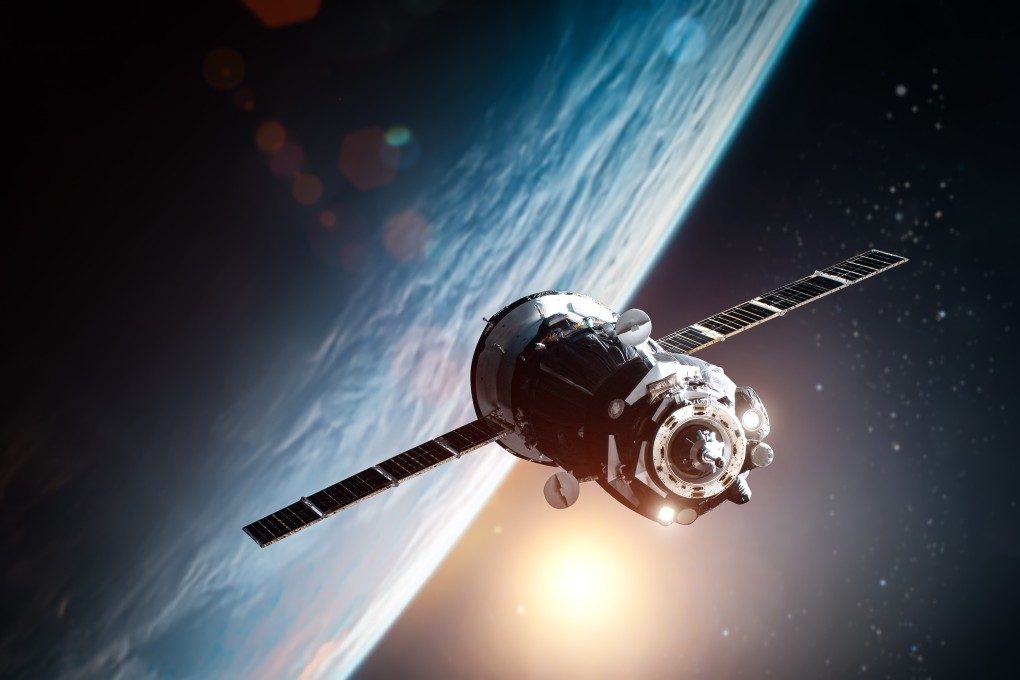 A spacecraft orbits Earth, as seen from space. The scammer in the Sapporo case claimed to be an astronaut running out of oxygen aboard such a vessel. Photo: Shutterstock