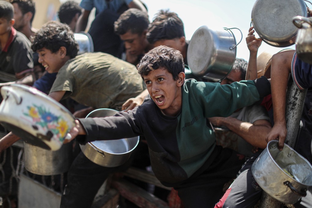 Palestinian children wait to receive food from a charity kitchen in Gaza City on Wednesday. Photo: APA Images/Zuma Press Wire/dpa