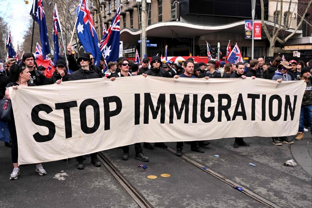 Protesters hold a banner during a “March for Australia” anti-immigration rally in Melbourne on August 31. Photo: AFP