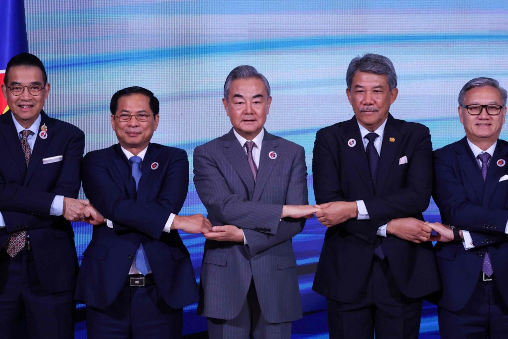 China’s Foreign Minister Wang Yi (centre) joins hands with his Southeast Asian counterparts at an Asean meeting in July. Photo: AFP