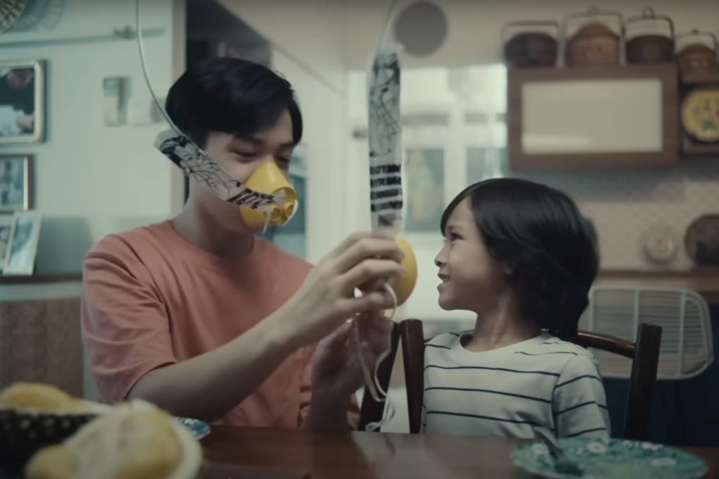 A still from Singapore Airlines’ new in-flight safety video shows a cut durian landing on a table, prompting diners to grab oxygen masks. Photo: YouTube