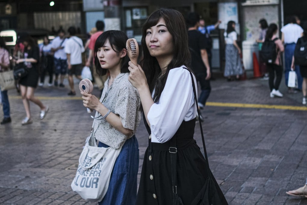 Japanese women cross the Shibuya crossing in Tokyo. Photo: Sopa Images/LightRocket/Getty Images