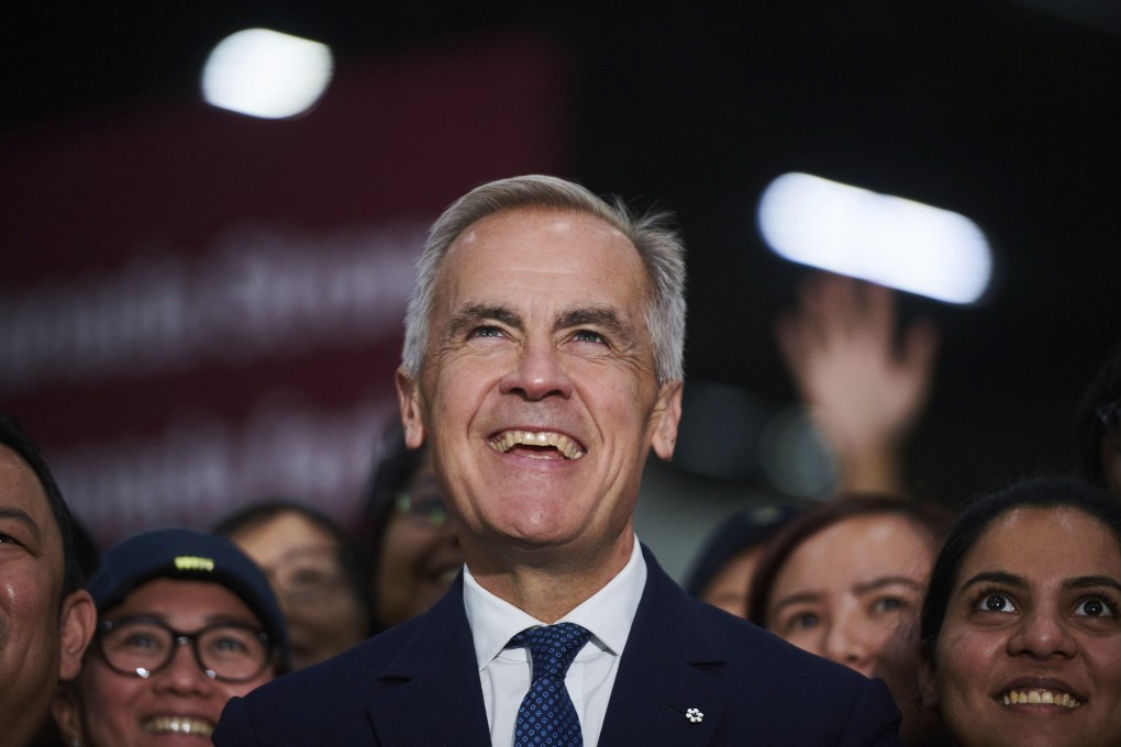 Canadian Prime Minister Mark Carney he takes photos with workers at a manufacturing facility in Mississauga, Ontario, on Friday. Photo: The Canadian Press via AP