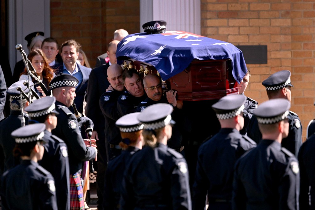 The coffin of police officer senior constable Vadim de Waart being carried following his funeral service in Melbourne on Friday. He was one of two Victoria Police officers killed in a shooting at Porepunkah in Victoria’s north-east last week. Photo: AFP