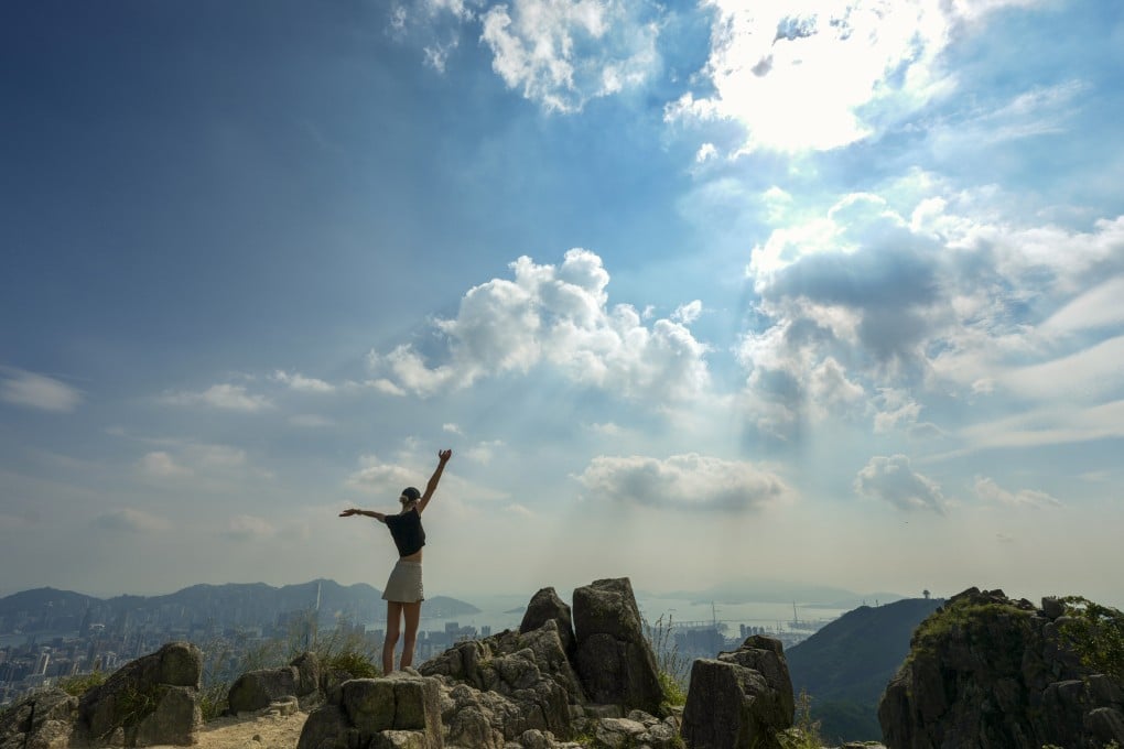 A woman enjoys the clear views from the top of Lion Rock. Photo: Karma Lo