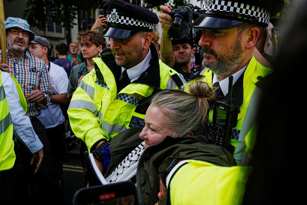Police officers detain a demonstrator on the day of the “Lift The Ban” rally organised by Defend Our Juries, challenging the British government’s proscription of “Palestine Action” under anti-terrorism laws, in Parliament Square, in London on Saturday. Photo: Reuters