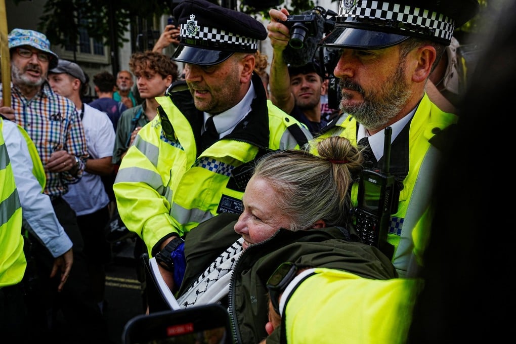 Police officers detain a demonstrator on the day of the “Lift The Ban” rally organised by Defend Our Juries, challenging the British government’s proscription of “Palestine Action” under anti-terrorism laws, in Parliament Square, in London on Saturday. Photo: Reuters