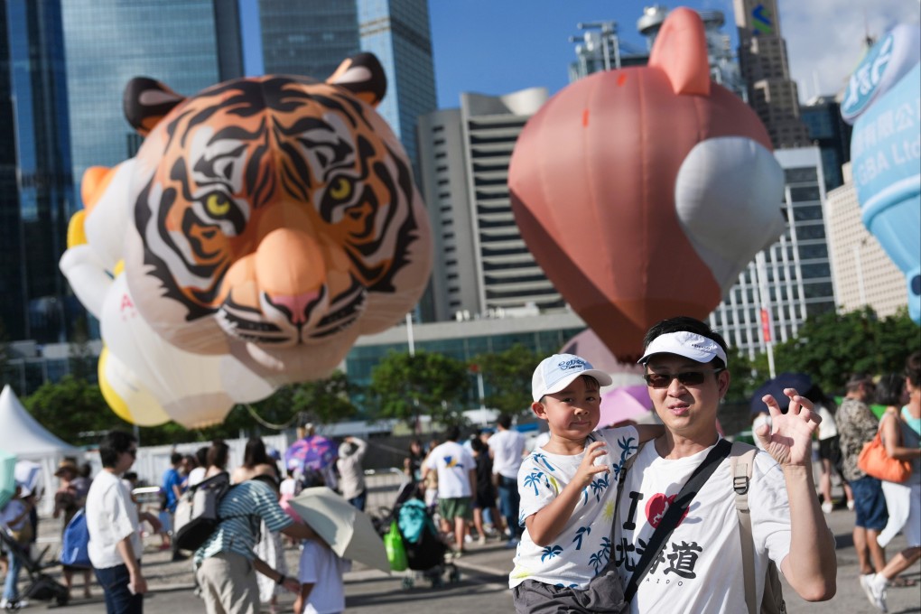 Visitors attend the third day of the hot-air balloon festival. Photo: Karma Lo