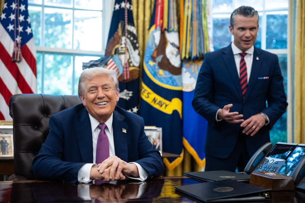 US President Donald Trump speaks in the Oval Office on Friday after signing executive orders including the renaming of the Department of Defence to the Department of War as US Defence Secretary Pete Hegseth looks on. Photo: EPA