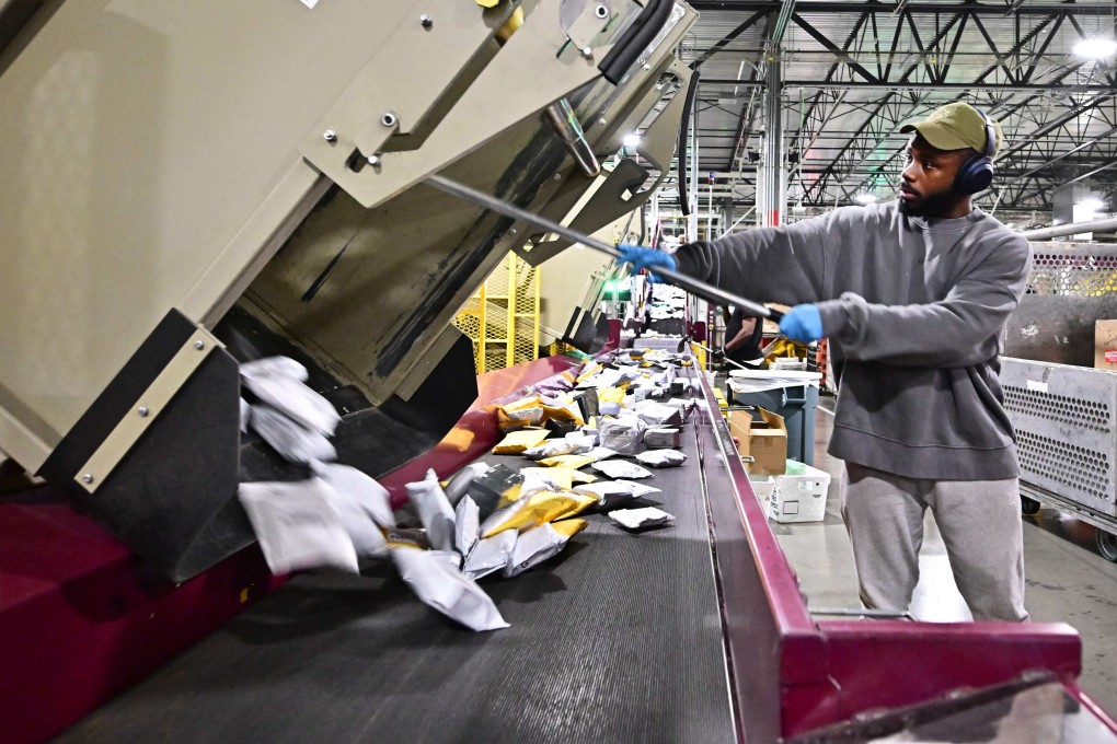 Postal workers sort through mail and packages at the Los Angeles Processing and Distribution Centre. The US on August 29 ended tariff exemptions on small packages entering the country from abroad. Photo: AFP