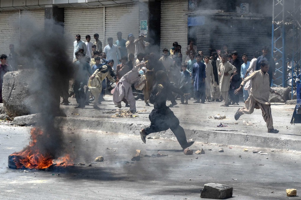 Protesters pelt stones during a strike called by the Balochistan National Party (BNP) in Quetta on Monday, against last week’s bombing at a political rally. Photo: AFP