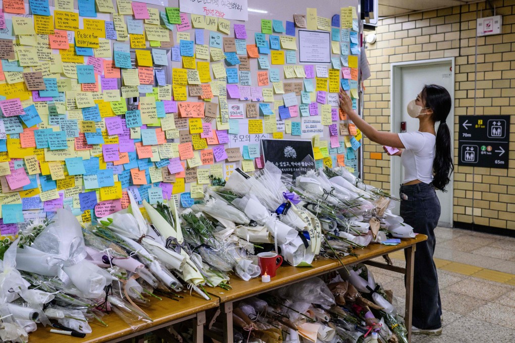 A woman pays her respects at Sindang Station in Seoul in September 2022, a few days after a man stabbed a female colleague who was working for Seoul Metro to death in a toilet at the station. Photo: AFP