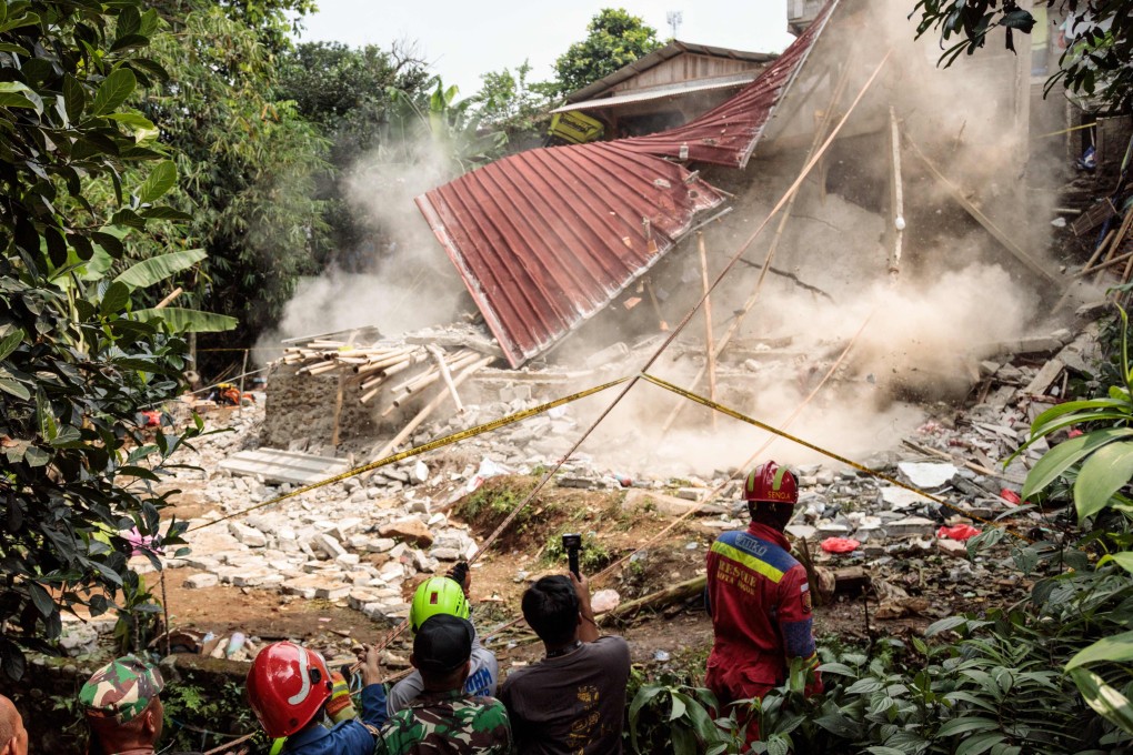 Rescue teams pull down the remains of a community Islamic study hall building after it collapsed while female Muslims were conducting studies to commemorate the birthday of the Prophet Muhammad, in Bogor, West Java on Sunday. Photo:  AFP