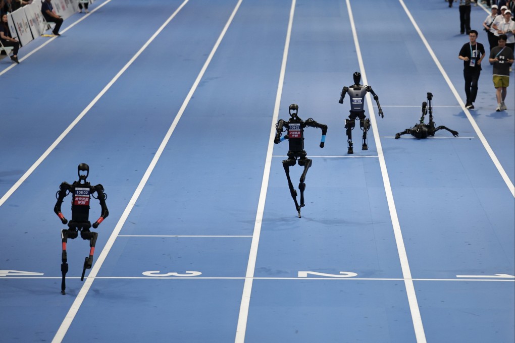 Humanoid robots take part in the 100m final race during the 2025 World Humanoid Robot Games in Beijing on August 17. In robotics, failures are not wasted. Each fall becomes training data. Photo: EPA