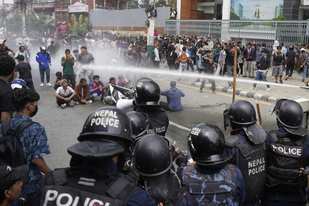 Riot police use a water cannon on protesters outside parliament in Kathmandu, Nepal, on Monday. Photo: AP