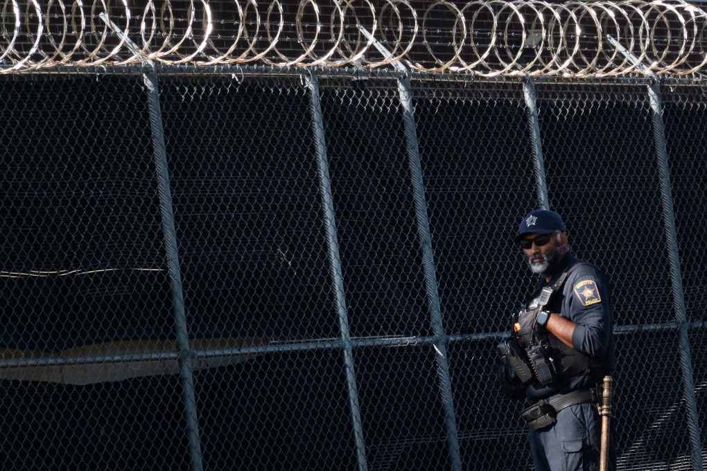 A police officer outside of an ICE facility in Broadview, Illinois. Immigrants are processed there before being deported. Photo: AFP