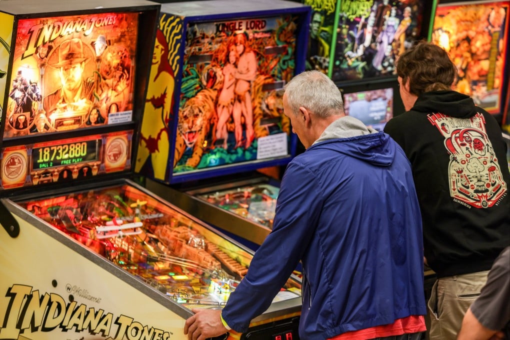 People play pinball machines at a tournament in Germany. The pinball market is seeing a revival around the world, with machines popping up in breweries, restaurants and dedicated pinball bars. Photo: Christoph Reichwein/dpa