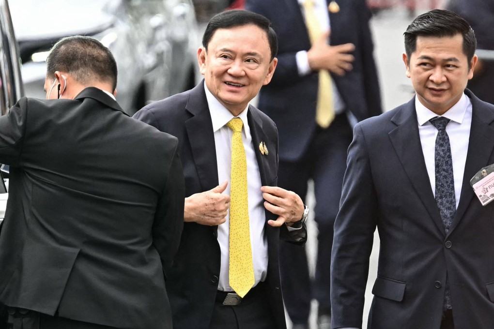 Thailand’s former prime minister Thaksin Shinawatra (centre) arrives with his lawyer Winyat Chatmontree (right) at the Supreme Court in Bangkok on Tuesday. Photo: AFP