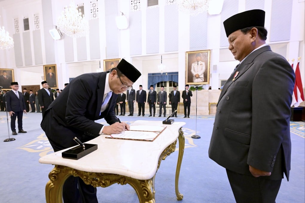 Indonesia’s newly appointed finance minister Purbaya Yudhi Sadewa (left) signs a document in front of President Prabowo Subianto during a swearing-in ceremony at the state palace in Jakarta on Monday. Photo: EPA