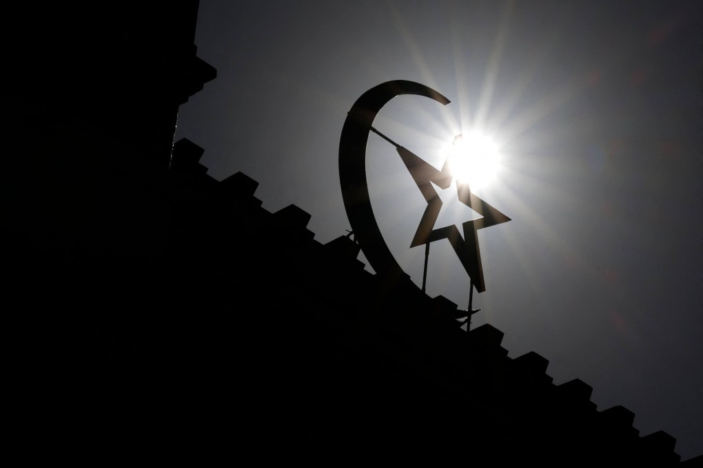 Late morning sunlight silhouettes the star and crescent at the entrance of the Great Paris Mosque. Photo: AFP
