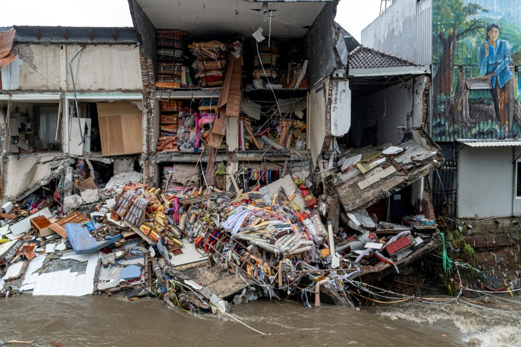 Goods lie scattered at a fabric store that collapsed after being hit by floods following overnight heavy rains in Denpasar on Wednesday. Photo: Reuters