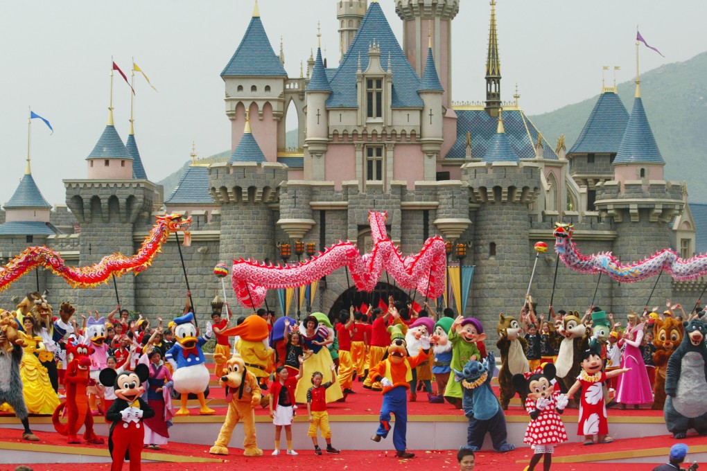 Mickey and Minnie Mouse perform on stage with other characters in front of the castle of Sleeping Beauty at the official opening of Hong Kong Disneyland on September 12, 2005. Photo: SCMP Archives