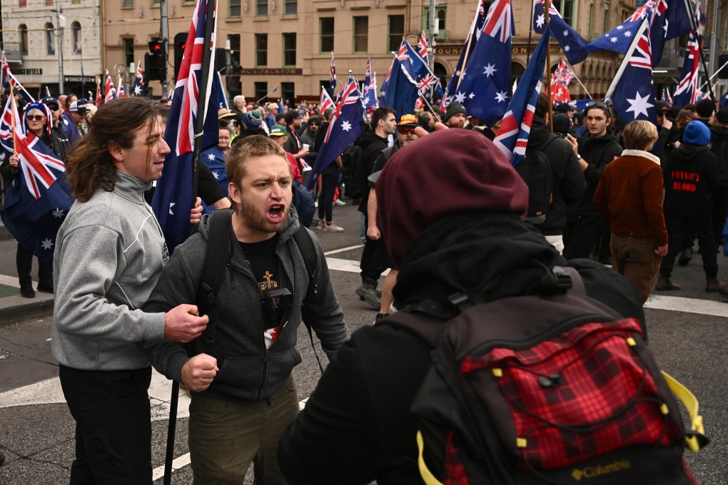 A scuffle breaks out as protesters gather outside Flinders Street Station in Melbourne, Victoria, during the “March for Australia” anti-immigration rally. Photo: AAP/DPA
