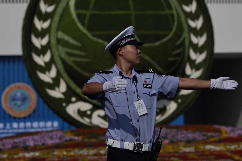 A security guard provides directions outside the Tianjin Meijiang Convention and Exhibition Centre before the start of the Shanghai Cooperation Organisation summit in Tianjin on September 1. Photo: EPA
