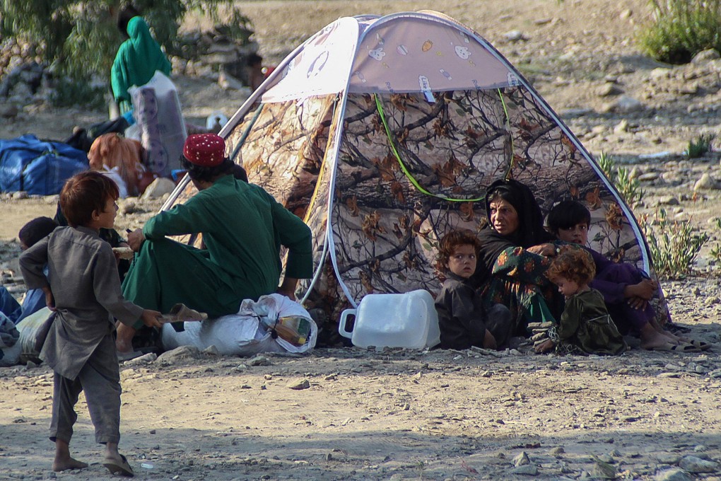 People sit outside a makeshift shelter after the earthquake in the Sawkay district of Afghanistan’s Kunar province, on Monday. Photo: AFP