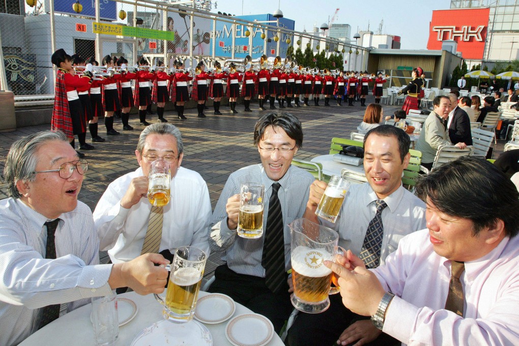 Japanese businessmen enjoy drinking beer at a beer garden on the rooftop of a Tokyo’s department store. Photo: AFP