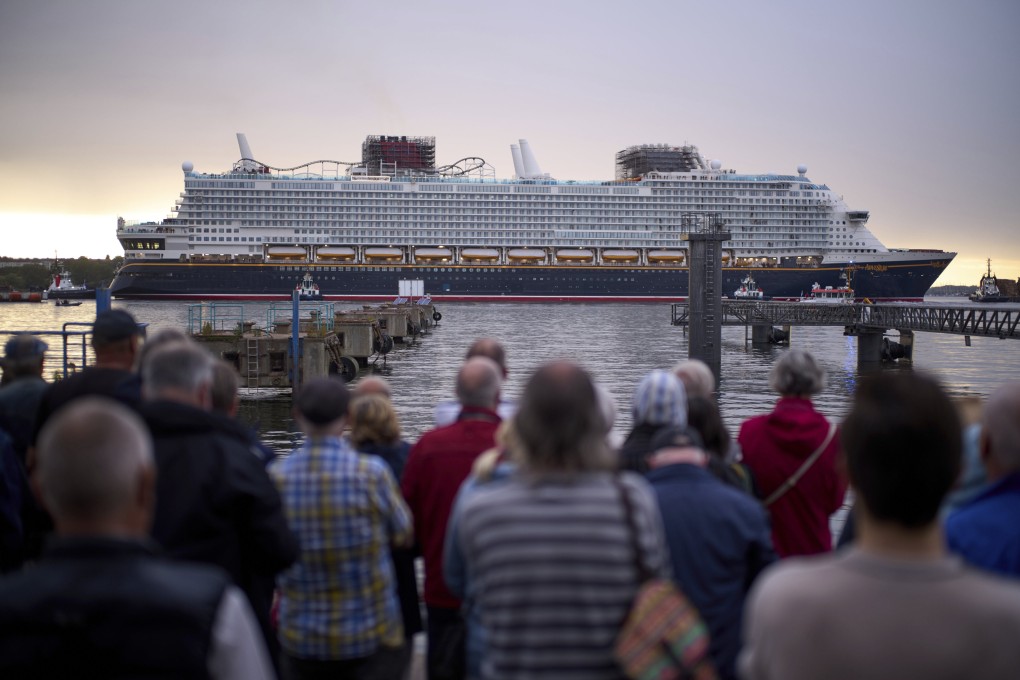 Spectators watch the departure of the Disney Adventure cruise ship from a harbour in Wismar, Germany, on September 1. Photo: AP