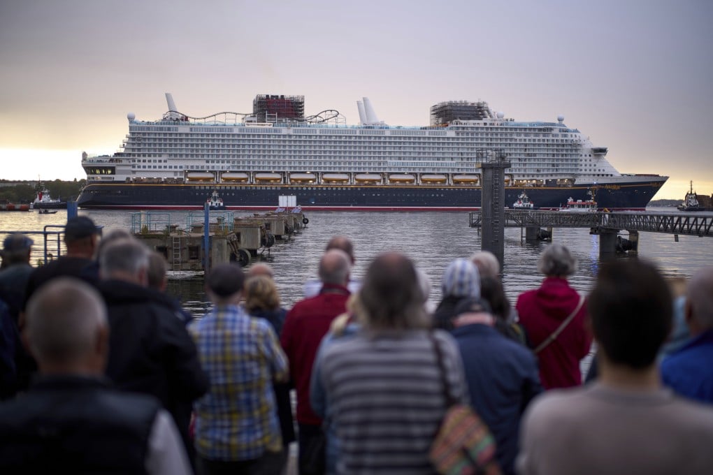 Spectators watch the departure of the Disney Adventure cruise ship from a harbour in Wismar, Germany, on September 1. Photo: AP