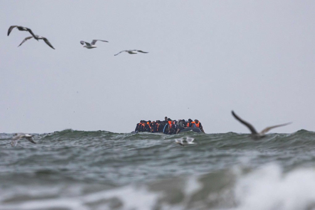 Migrants onboard a smuggler’s boat attempt to cross the English Channel off the beach of Hardelot in Neufchatel-Hardelot, northern France. Photo: AFP