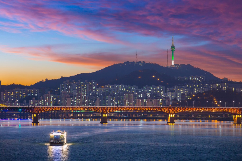 A view of Seoul after sunset, as a sightseeing boat sails on the Han River. Photo: Shutterstock