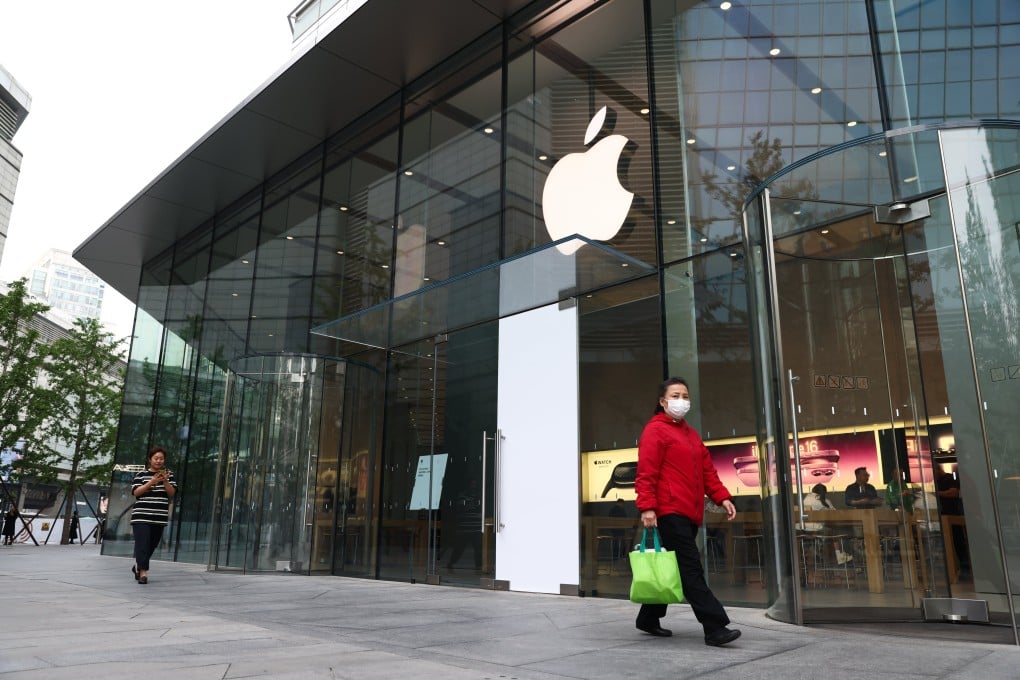 People walk beside an Apple store in Beijing on May 12. Photo: EPA-EFE