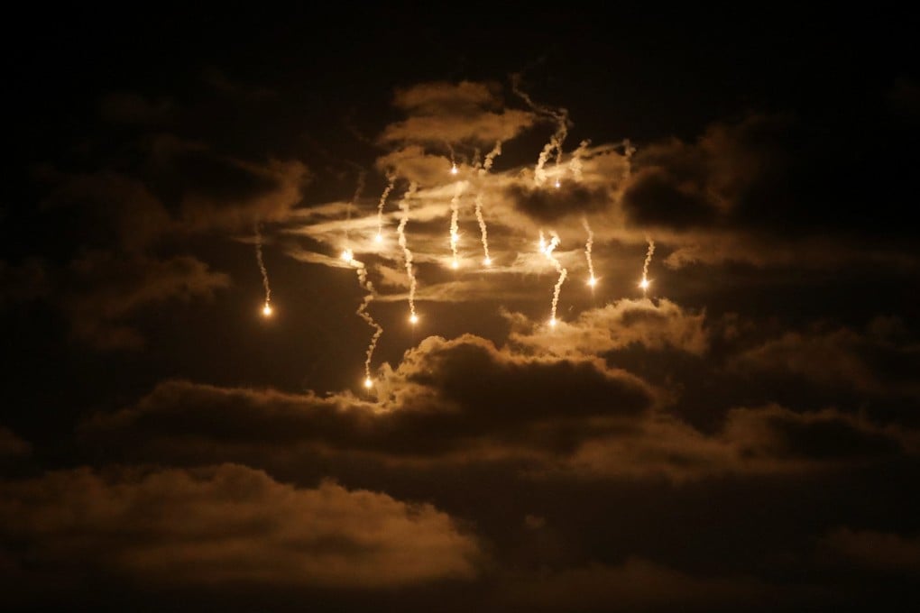 Flares fired by Israeli forces fall over Gaza amid a military offensive on Wednesday. Photo: Reuters