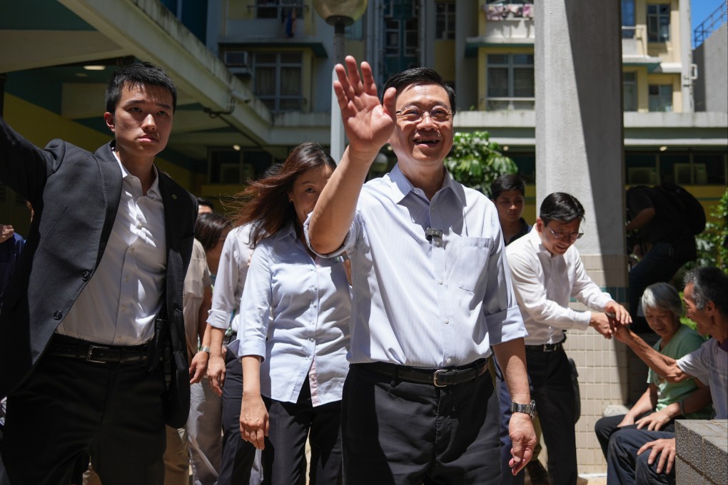Chief Executive John Lee waves while visiting Lower Ngau Tau Kok Estate, in Kwun Tong, on August 23. Photo: Eugene Lee
