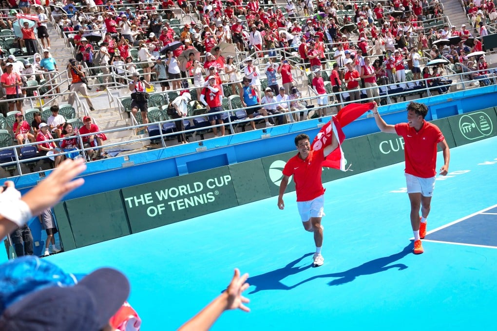 Coleman Wong (right) and Wong Chun-hun walk around Victoria Park Tennis Stadium’s centre court with the Hong Kong flag after their doubles victory. Photo: Karma Lo