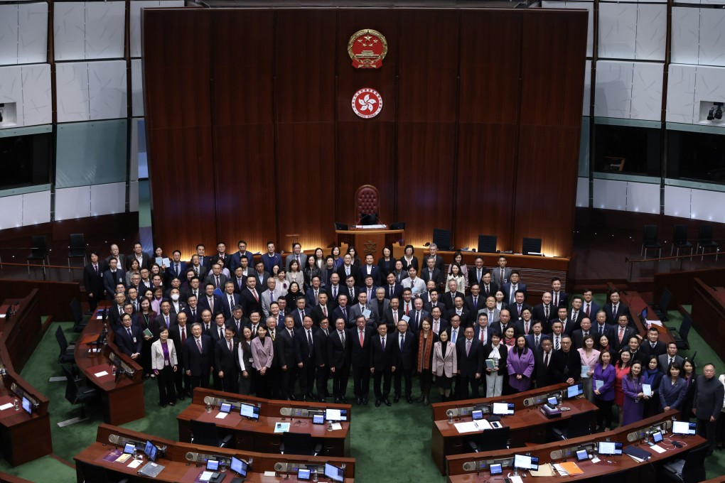 Chief Executive John Lee (green tie) and lawmakers in the chamber of the Legislative Council in March 2024 after successfully enacting the Article 23 national security law. Photo: Yik Yeung-man