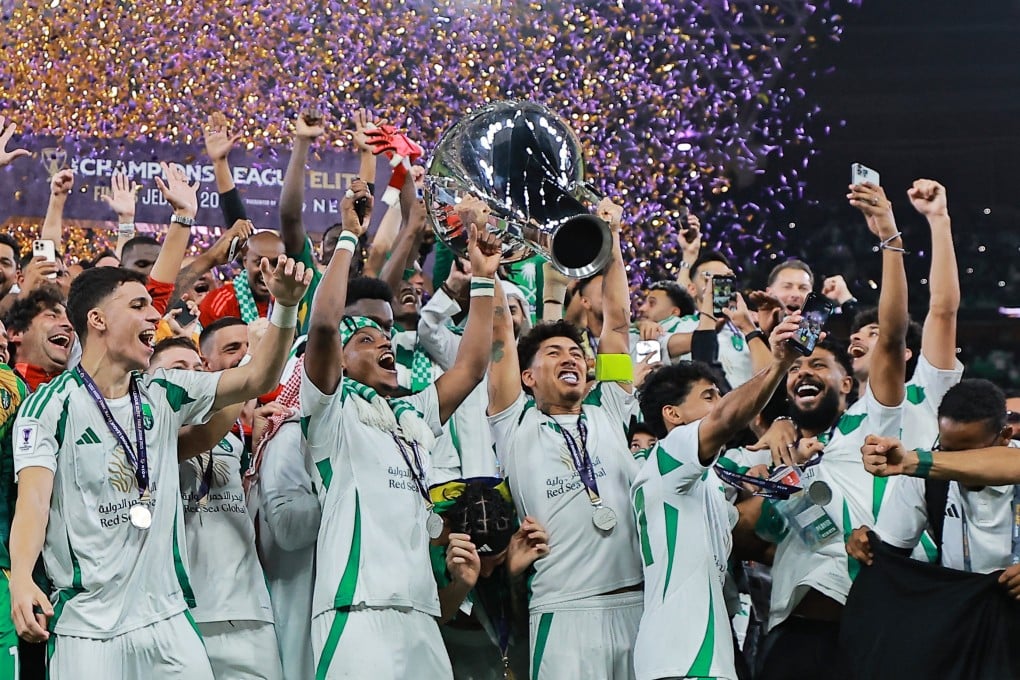 Al Ahli’s Roberto Firmino lifts the trophy as he celebrates with teammates after winning the Asian Champions League. Photo: Reuters