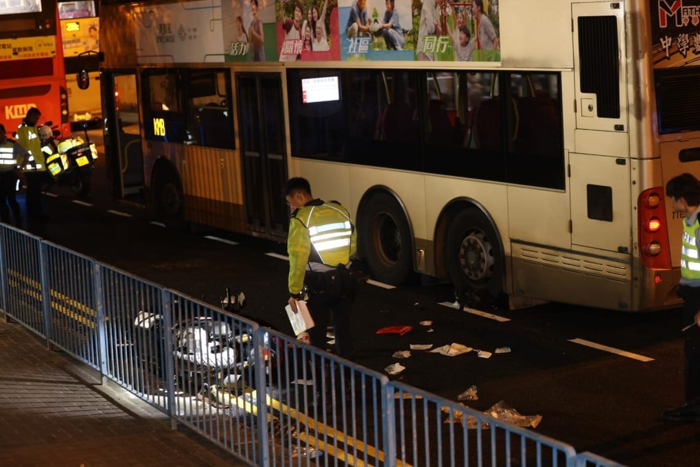 Police officers inspect the scene of the accident on Kwun Tong Road. Photo: SCMP