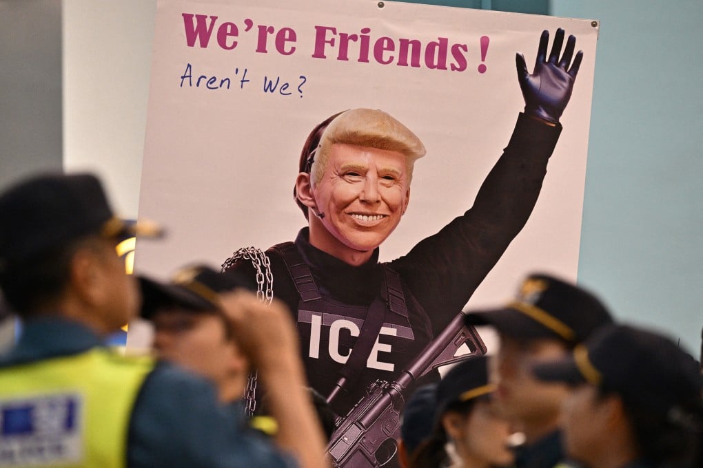 A banner showing a depiction of US President Donald Trump is displayed by a protester at Incheon International Airport in Incheon on Friday, after the arrival of a Korean Air flight bringing hundreds of South Korean workers back after their detention in a US immigration raid at a Hyundai-LG plant in Ellabell, Georgia. Photo: TNS