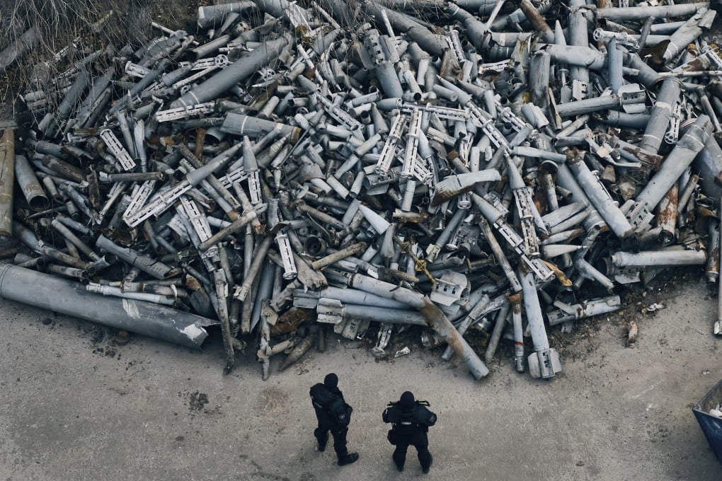 Police officers look at collected fragments of Russian rockets, including cluster rounds, that hit Kharkiv in 2022. Cluster munitions can be dropped from planes or fired from artillery before exploding in mid-air and scattering bomblets over a wide area. Photo: AP