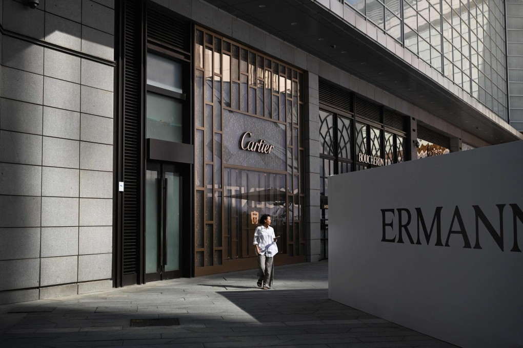 A woman walks past a Cartier store at a shopping mall in Beijing on Sunday. Photo: AFP