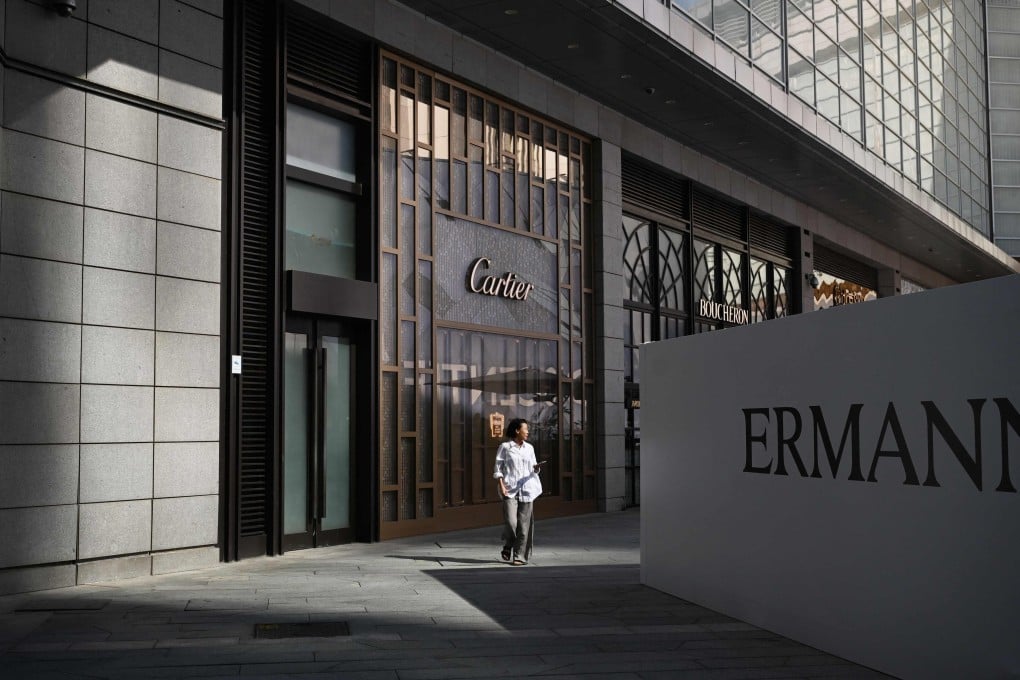 A woman walks past a Cartier store at a shopping mall in Beijing on Sunday. Photo: AFP