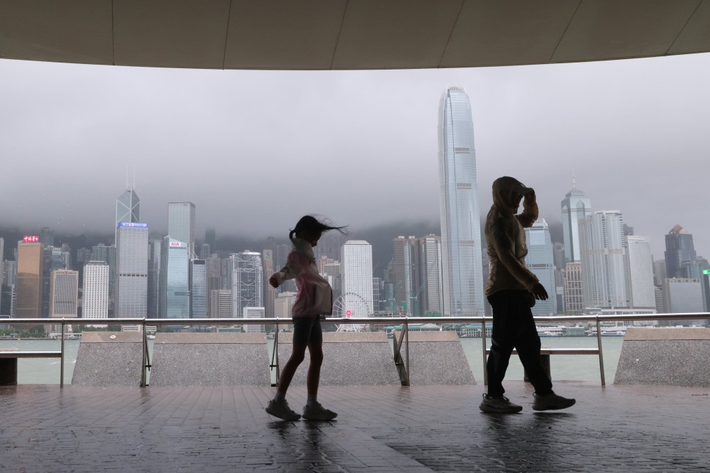People walk along Tsim Sha Tsui’s waterfront during a No 8 typhoon signal last week. Photo: Jelly Tse