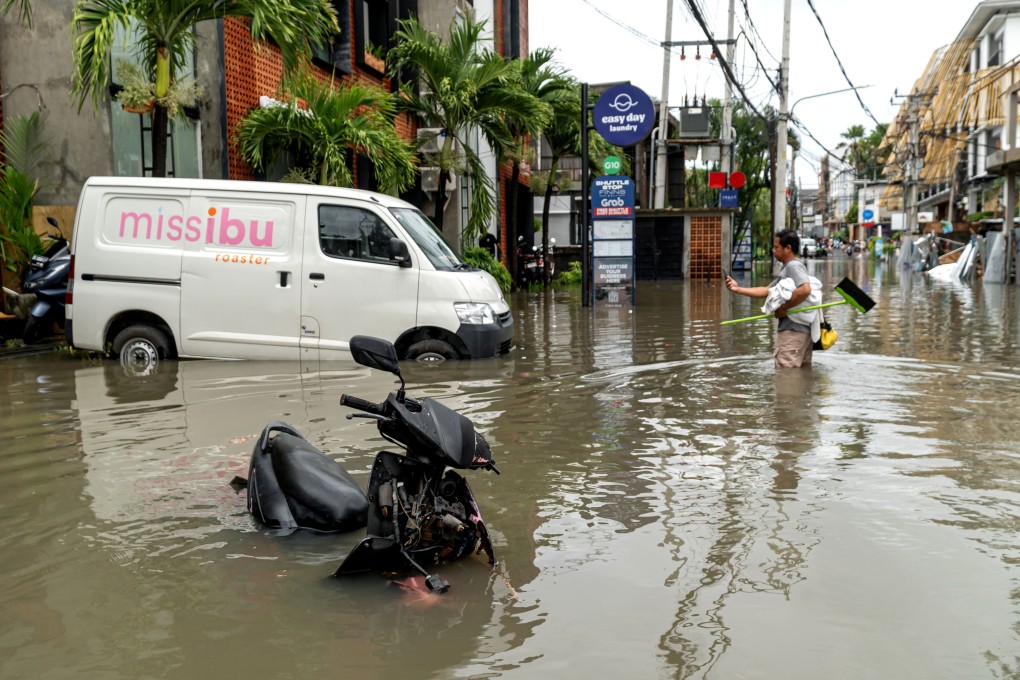 A man stands in flood water after heavy rain hit Canggu in Badung regency, Bali, Indonesia, on Monday. Photo: Xinhua