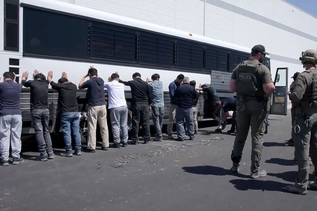 Detainees are made to stand against a bus before being handcuffed, during a surprise raid on September 4 at HL-GA Battery Company near Savannah, Georgia. Photo: US Immigration and Customs Enforcement/Handout via Reuters